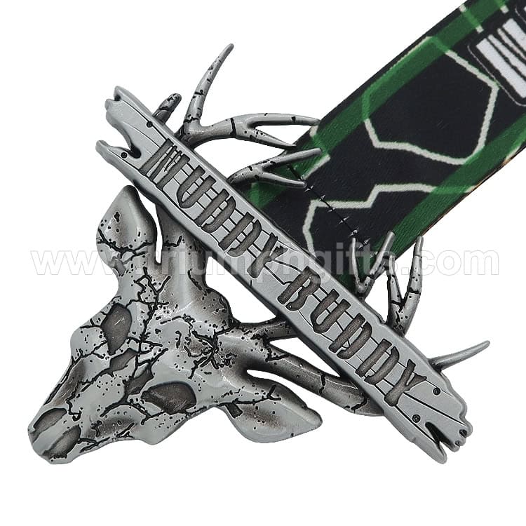 Silver dinosaur skull with a metal band reading "APEX PREMIER" and a green and black patterned ribbon, used as a promotional award or medal.