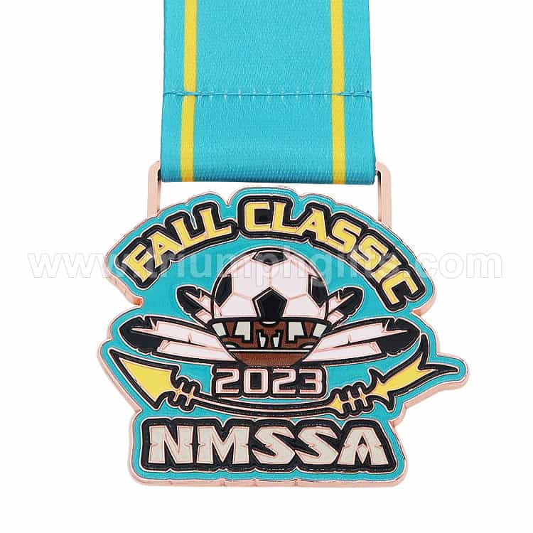 FALL CLASSIC 2023 NMSSA enamel pin featuring a soccer ball and dragonfly design with a blue and yellow ribbon strap, perfect for sports awards and promotional events.