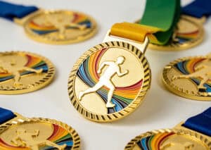 Medal with a running figure and rainbow-colored design, awarded for athletic achievement. Perfect for sports events, medals, and trophies. Customizable for various athletic competitions.