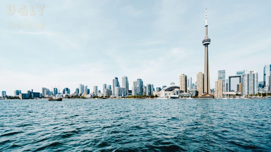 Distinctive Toronto skyline with CN Tower over waterfront, modern cityscape in Canada.