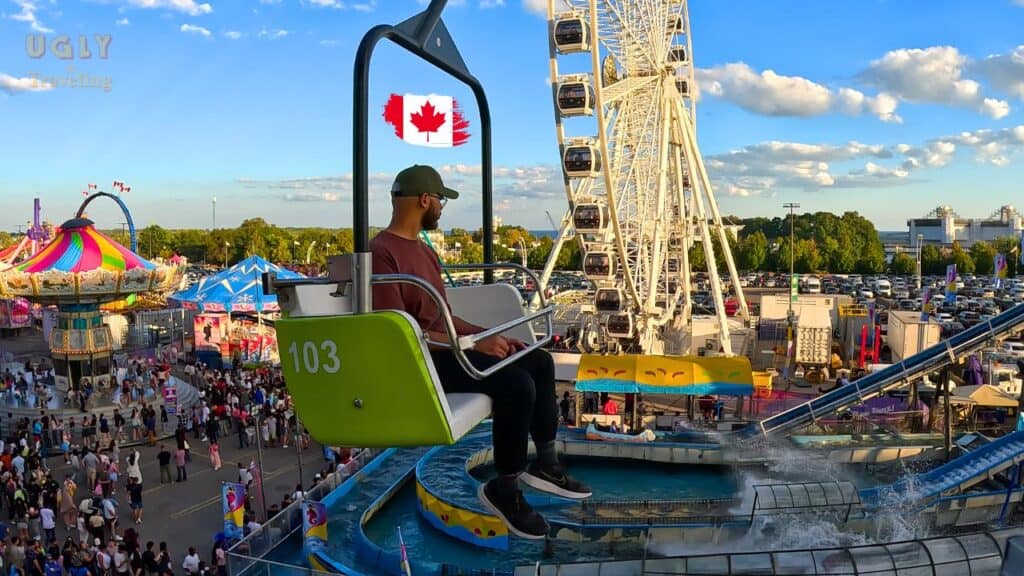 Colorful amusement park ride with a Ferris wheel and crowds, showcasing fun travel destinations in Canada.