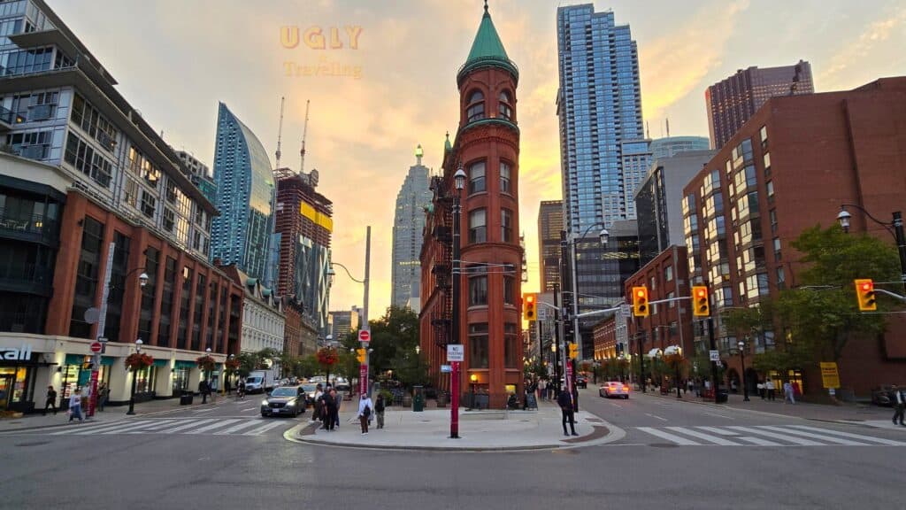 Historic red brick building in downtown urban city skyline at sunset.