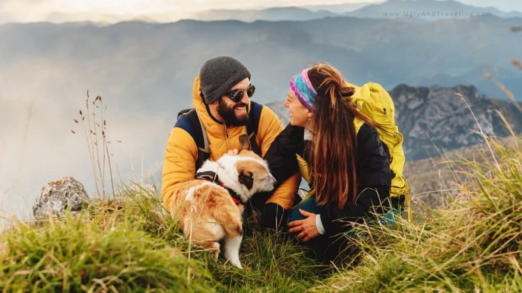 Happy hikers with dog enjoying mountain scenery and outdoor adventure.