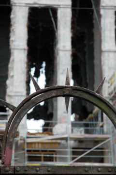 1. Rostiges Eisen Tor im Bauprojekt, im Hintergrund sichtbar alte Gebäudestruktur.