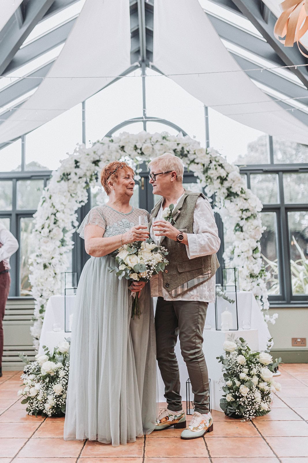 LGBTQ couple portrait in coastal gardens at Titchwell Manor – Norfolk wedding photographer