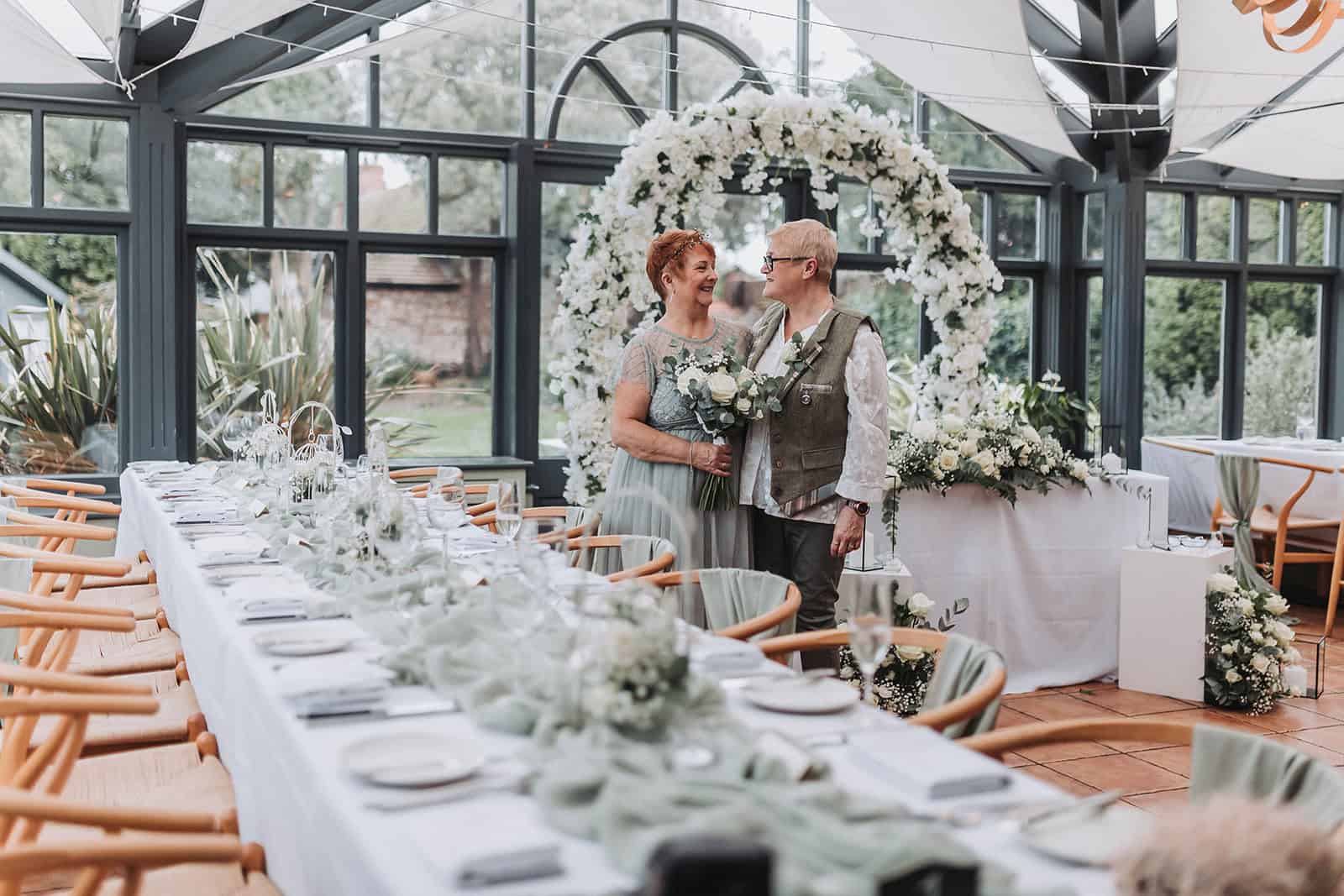 LGBTQ couple portrait in coastal gardens at Titchwell Manor – Norfolk wedding photographer