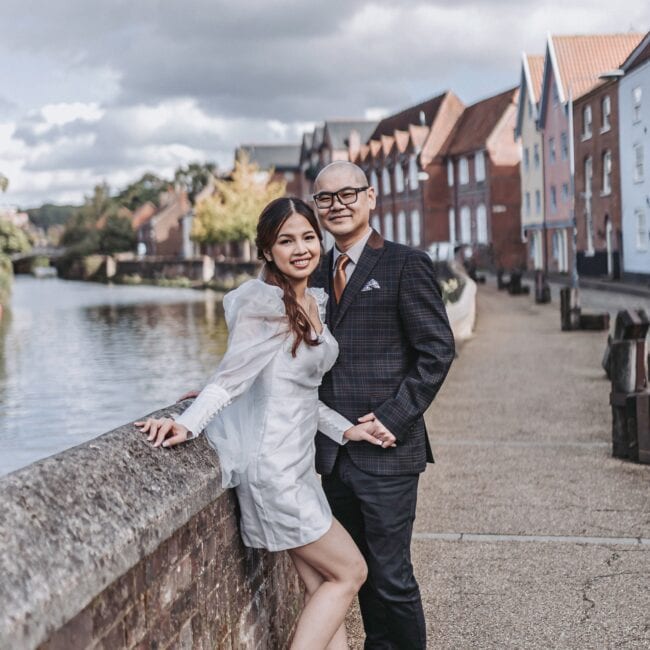 Norwich City Centre Engagement Shoot couple sharing a romantic embrace beside the historic streets of Norwich City Centre