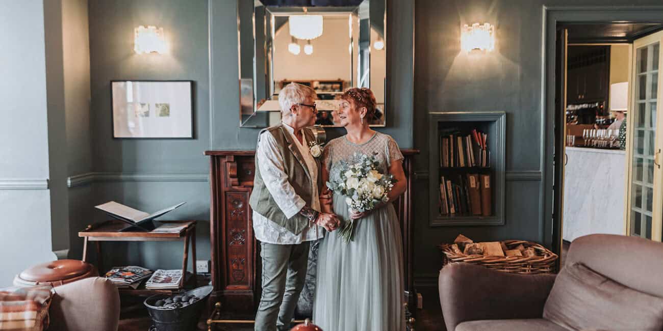 LGBTQ couple portrait in coastal gardens at Titchwell Manor – Norfolk wedding photographer