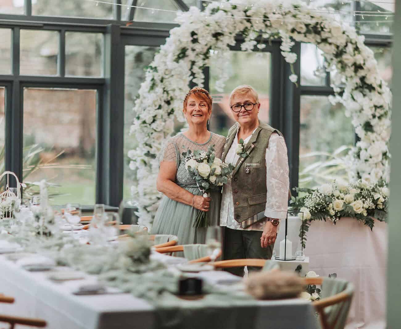 LGBTQ couple portrait in coastal gardens at Titchwell Manor – Norfolk wedding photographer