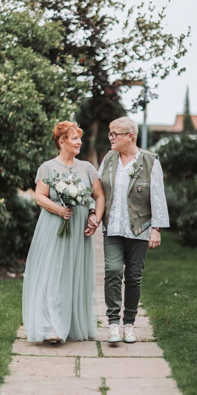 LGBTQ couple portrait in coastal gardens at Titchwell Manor – Norfolk wedding photographer