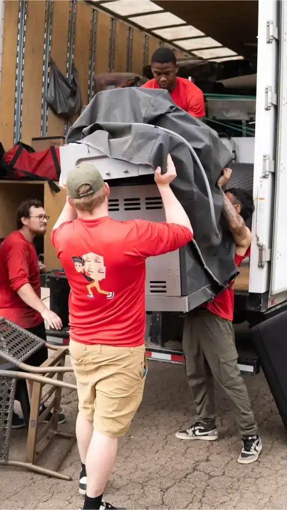Residential moving experts loading furniture and appliances into a moving truck in Edmonton. Reliabl.