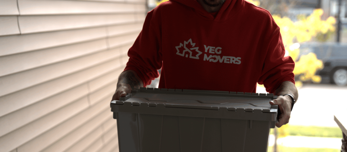Person holding a secure container for transporting pet fish during a move.