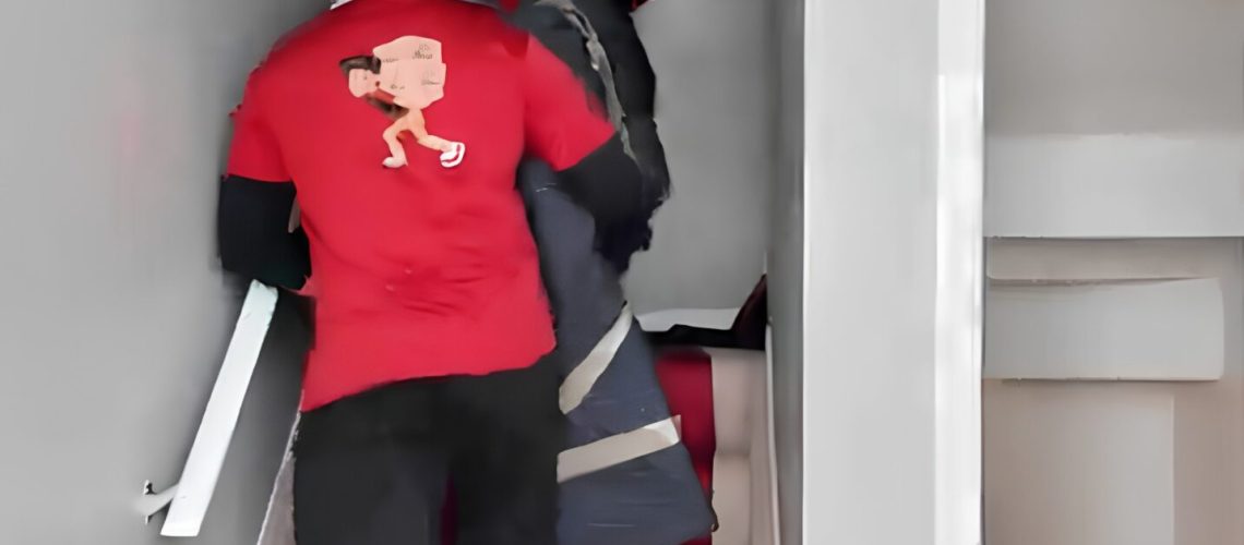 People carrying furniture up stairs during a move in Edmonton.