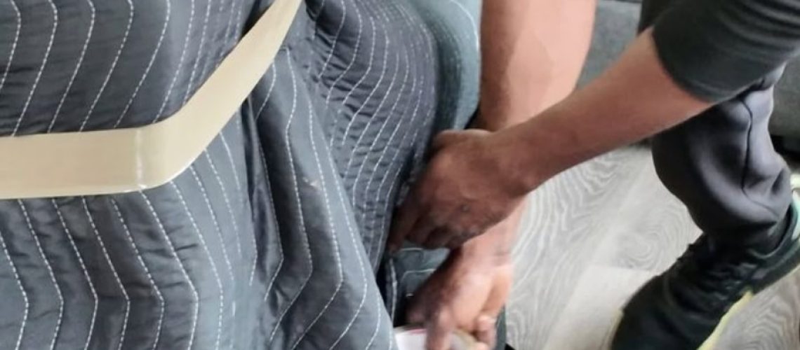 Mover securing furniture with tape during a professional move in Edmonton.