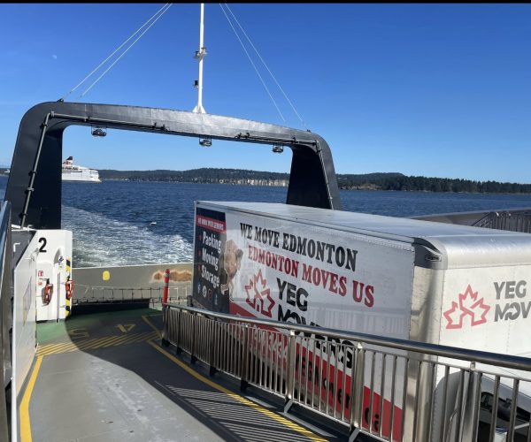 yeg movers truck at cargo ship by sea