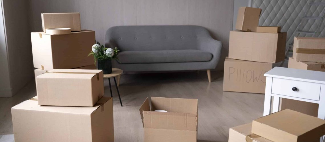 Moving boxes ready for packing and transportation in a modern living room.