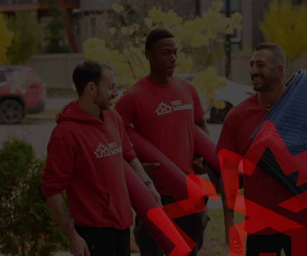 Edmonton moving team carrying boxes and furniture outdoors.