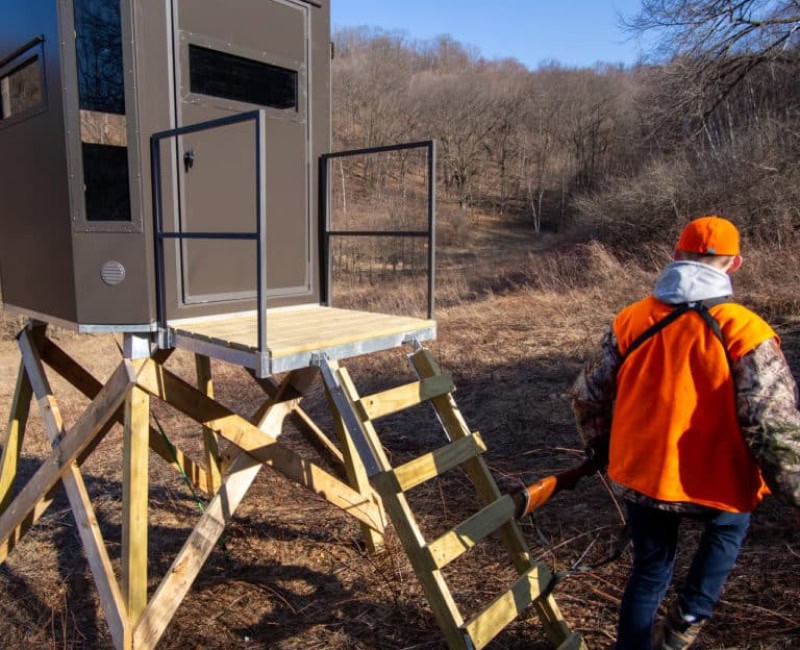 hunter walking away from his hunting blind