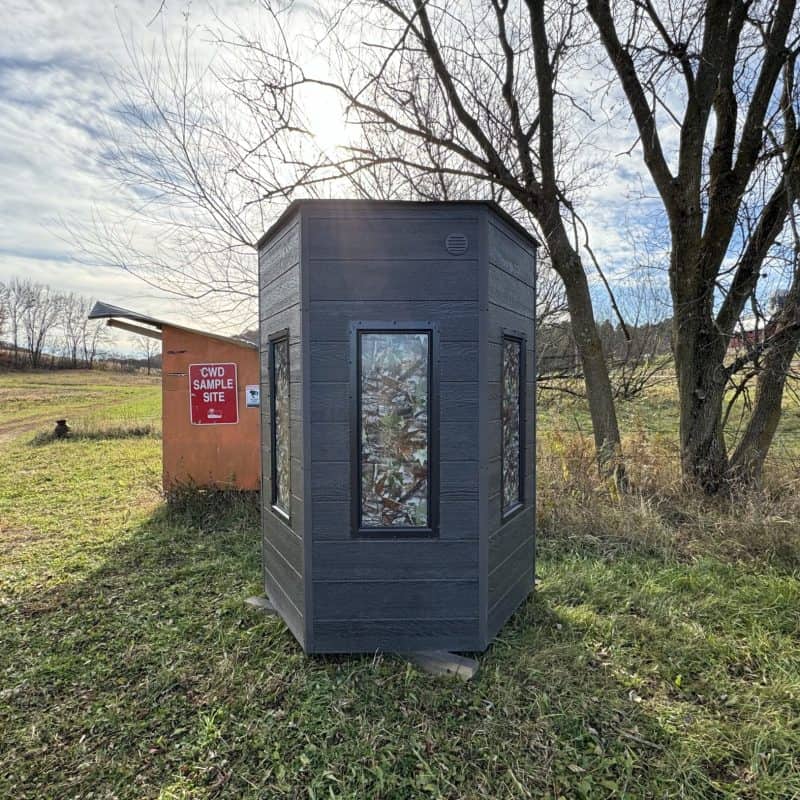 Camo window film applied to a small outdoor structure for privacy and aesthetic appeal.