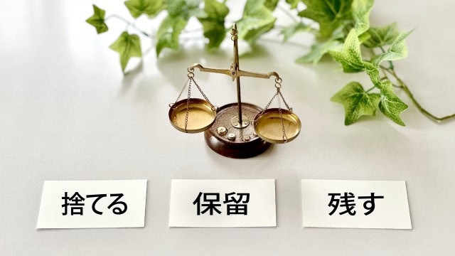 「捨てる・保留・残す」の選択肢と天秤が並んだ断捨離のイメージ写真