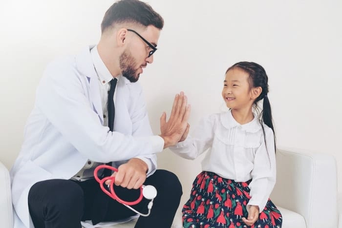 Family Doctor with little girl patient