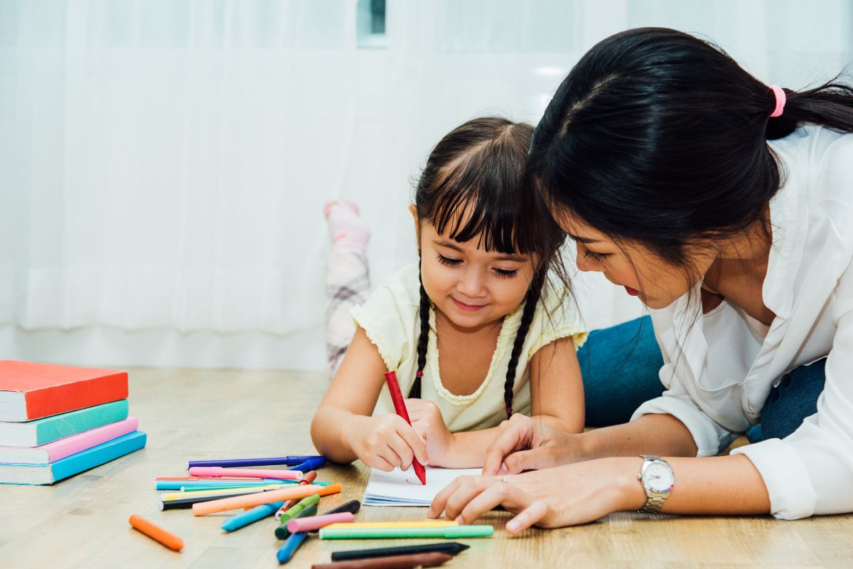A kid being taught by a teacher one on one, educational summer camp for kids