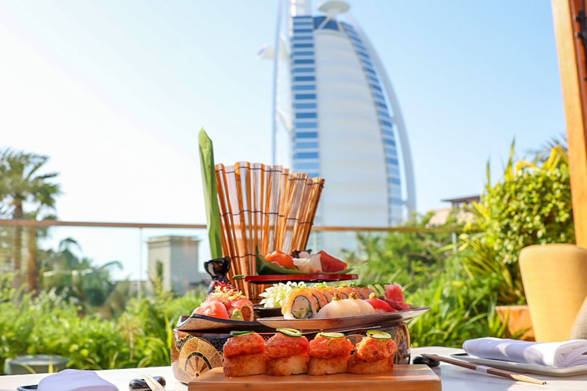 A plate of various sushi and nigiri overseeing the Burj Al Arab in Dubai at Kayto for business lunch