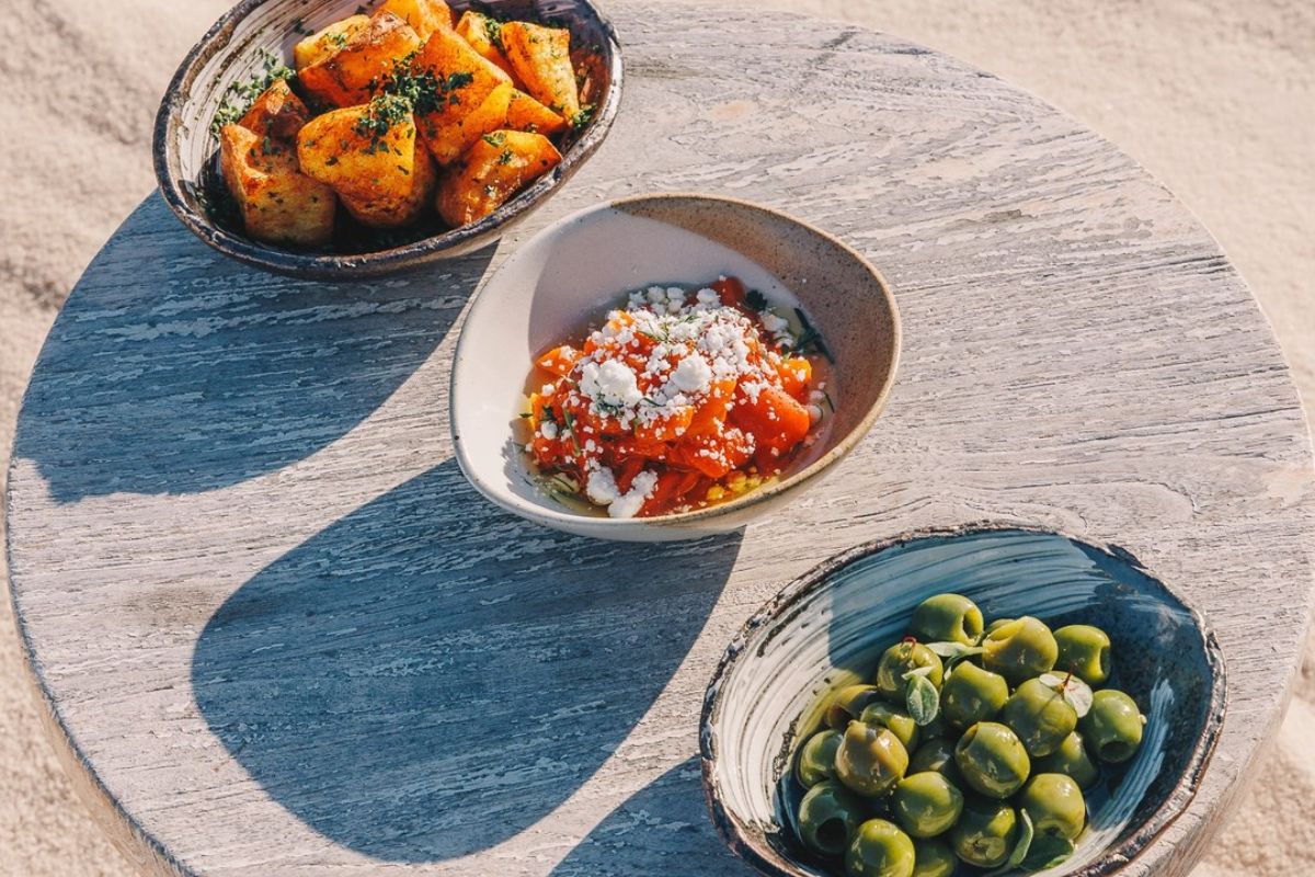 Various business lunch dishes like olives, roasted potatoes and tomato pasta at SAL Jumeirah Burj Al Aran