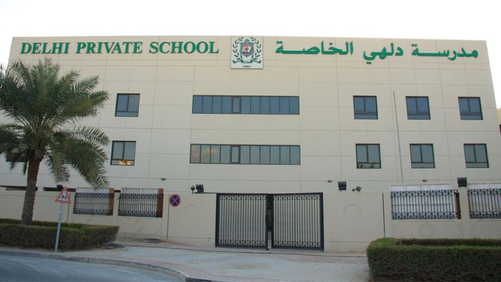 Modern exterior of Delhi Private School Dubai with signage in English and Arabic.