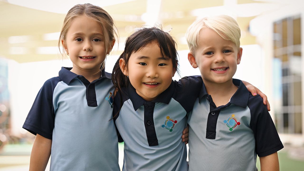 Children smiling at GEMS World Academy Dubai in Yalla Dubai Life.