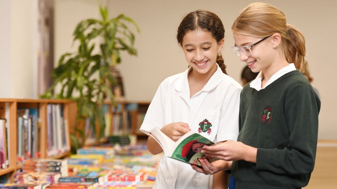 Students reading in a school library at Jumeirah College.