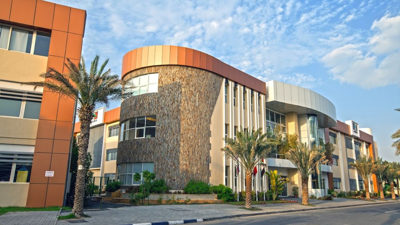 Modern French international school building in Dubai with palm trees.