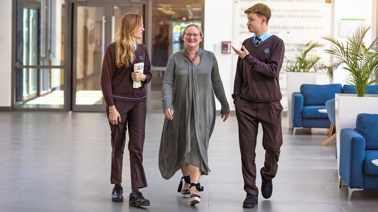 Students and teacher at North London Collegiate School Dubai entrance.