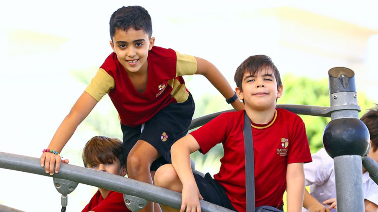 Happy children at Raffles International School in Dubai, engaging in outdoor activities.