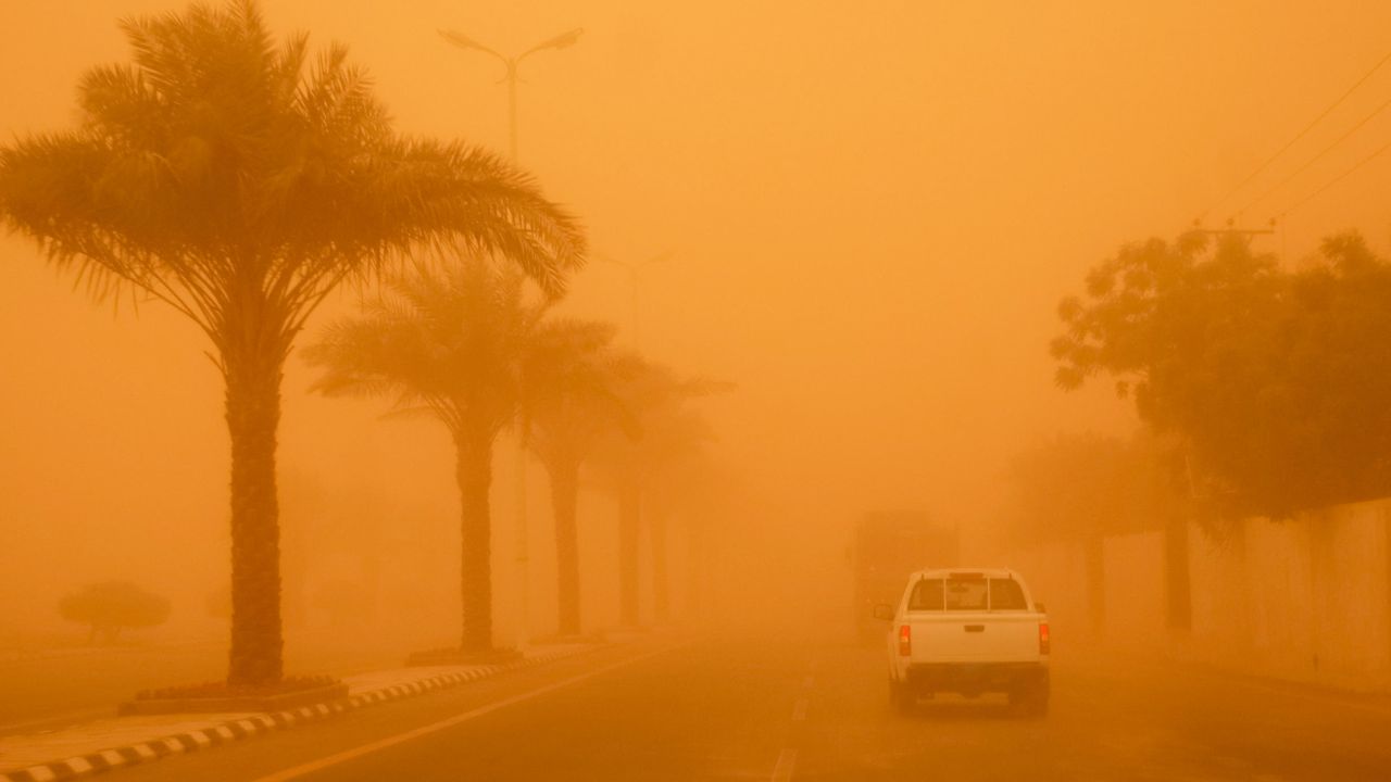 car driving through sandstorm