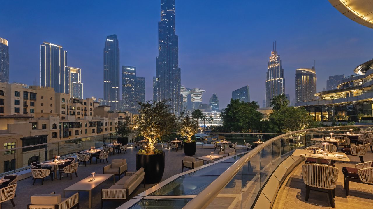 Elegant rooftop dining with Dubai skyline views.