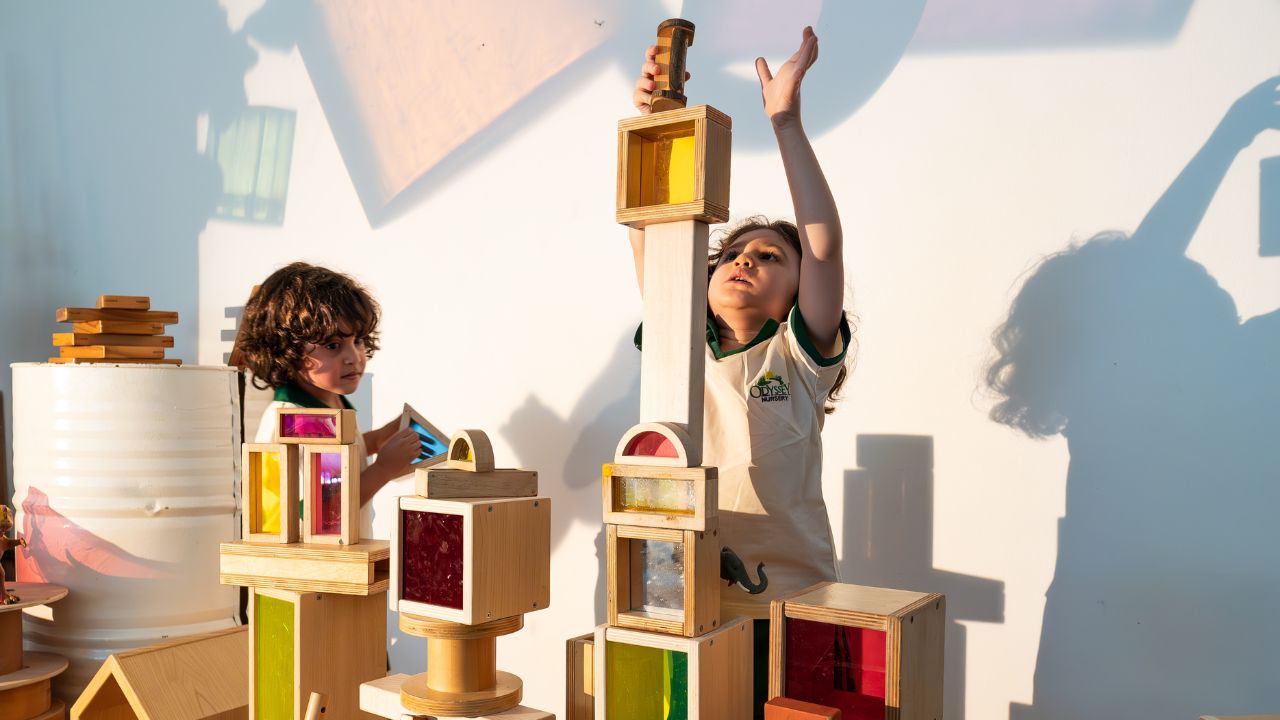 Children playing with wooden blocks at Odyssey Nursery.