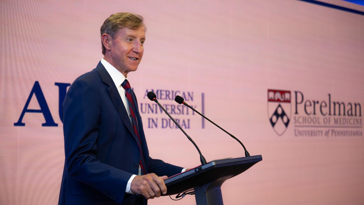 Man speaking at medical school launch event in Dubai, promoting healthcare education.