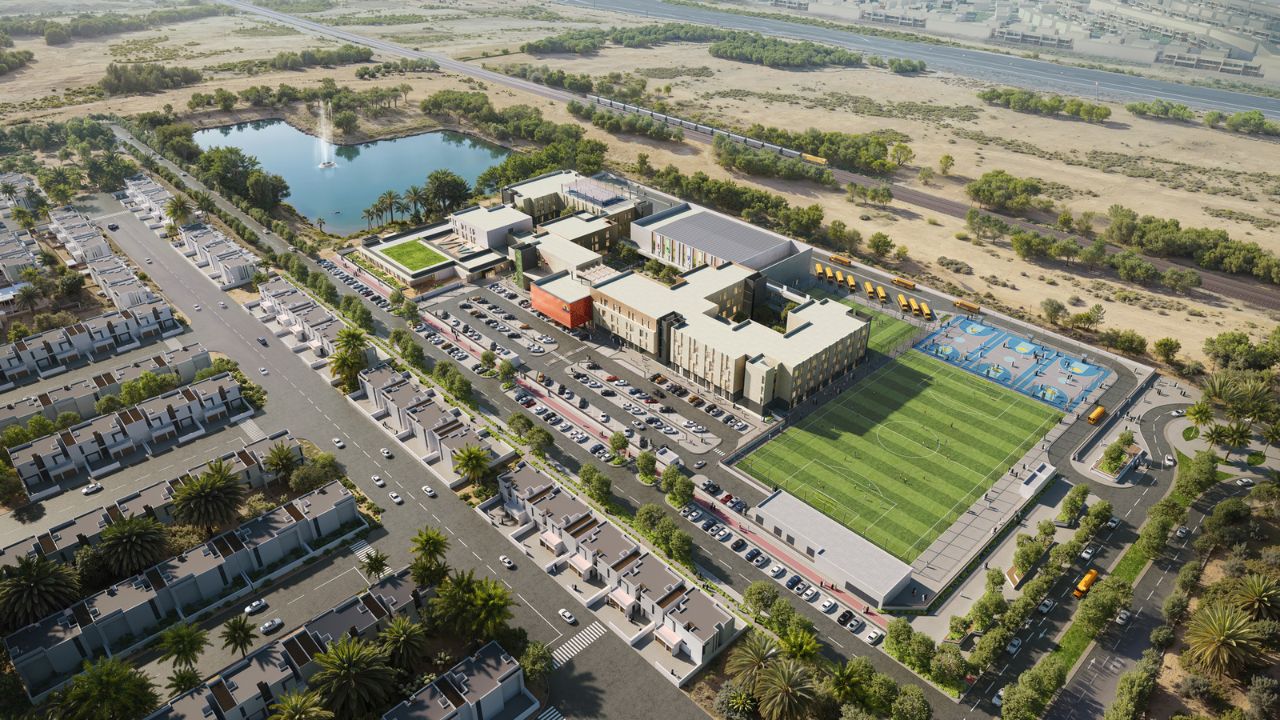 Modern school campus in Dubai with sports facilities.