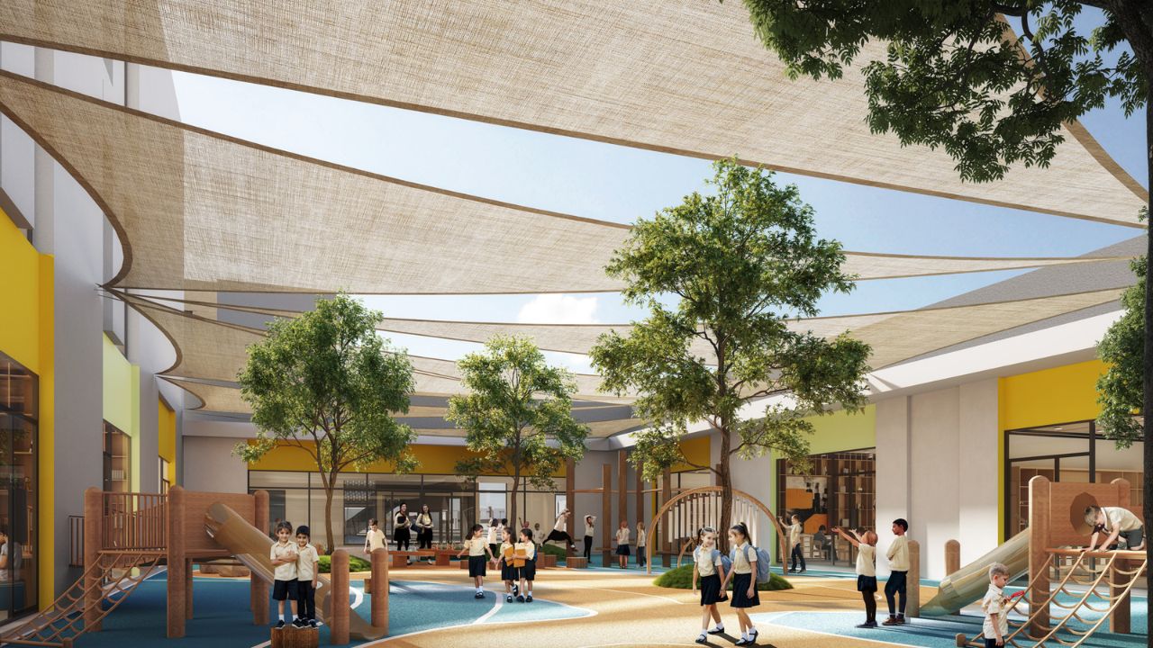 Vibrant outdoor community space at Yalla Dubai with children playing and relaxing under shade sails.
