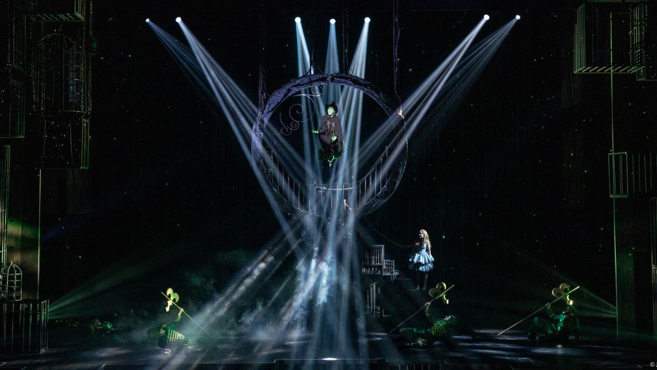Wicked musical performance in Dubai with dramatic stage lighting and cast.