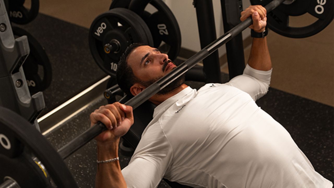 Man lifting weights during Dubai Fitness Challenge 2025 event.