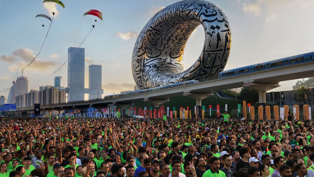 Crowds at Dubai Fitness Challenge 2025 with iconic Dubai Frame in background.