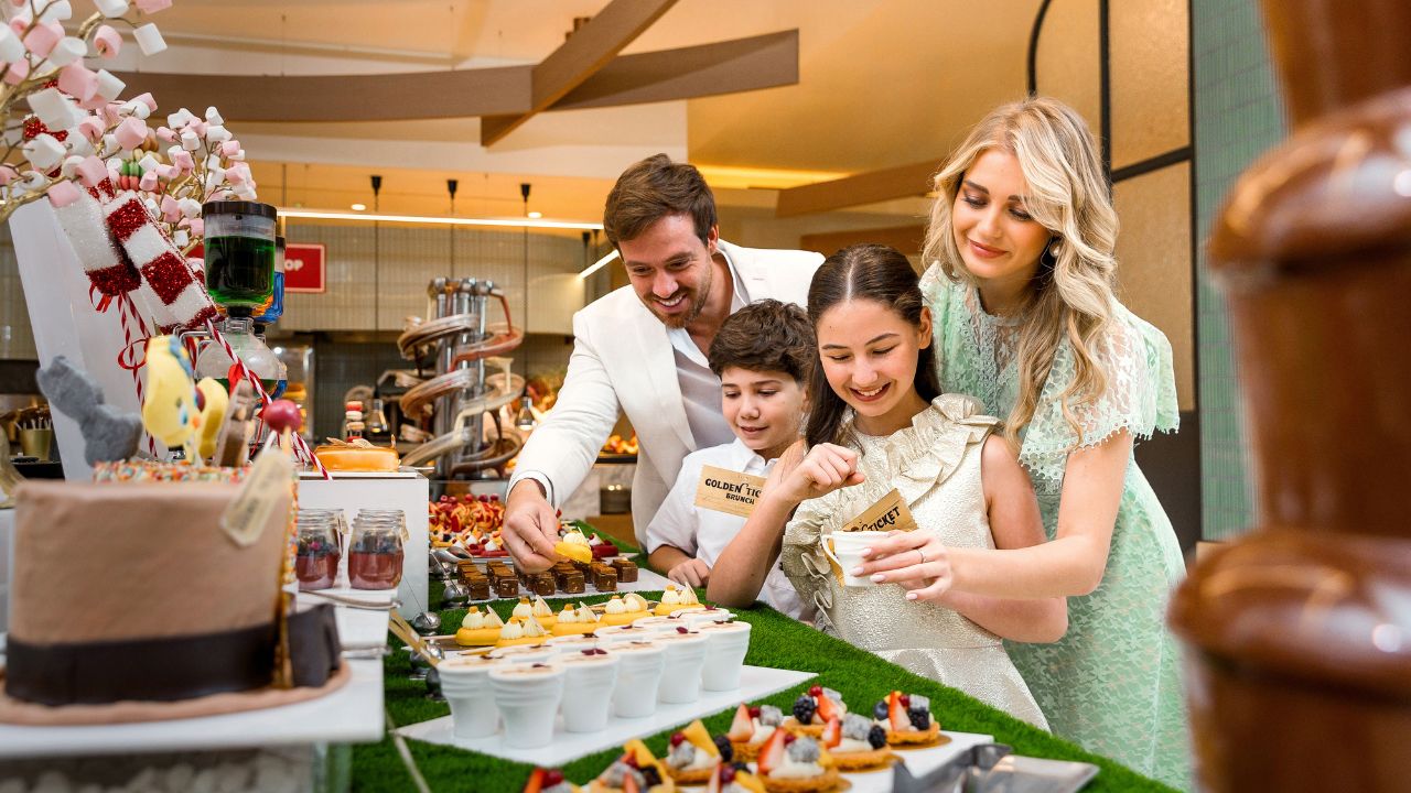 Family happily selecting desserts at a family-friendly event in Dubai.
