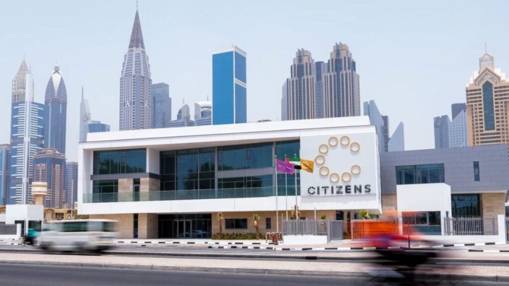 Modern Citizens School building with Dubai skyline background.