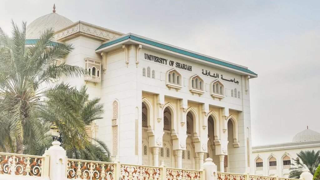 University of Sharjah campus with traditional architecture and palm trees.