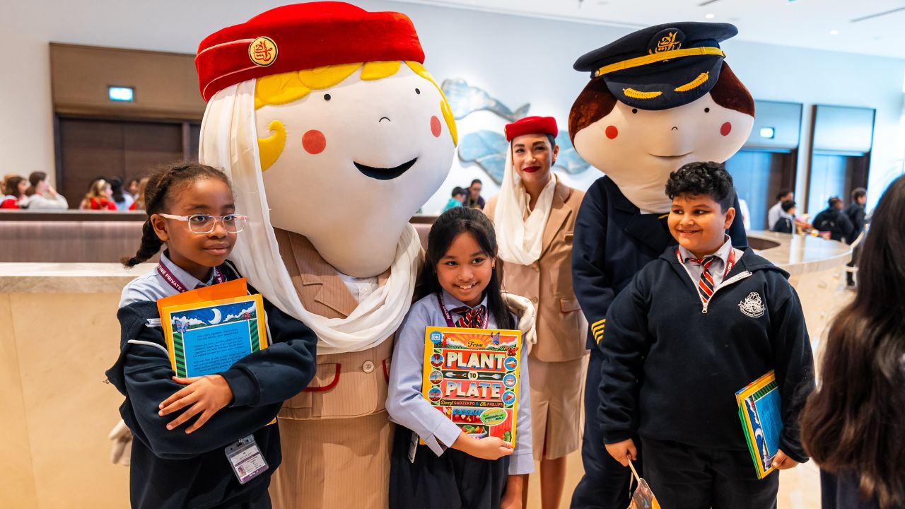 Children with characters at Dubai literature event.