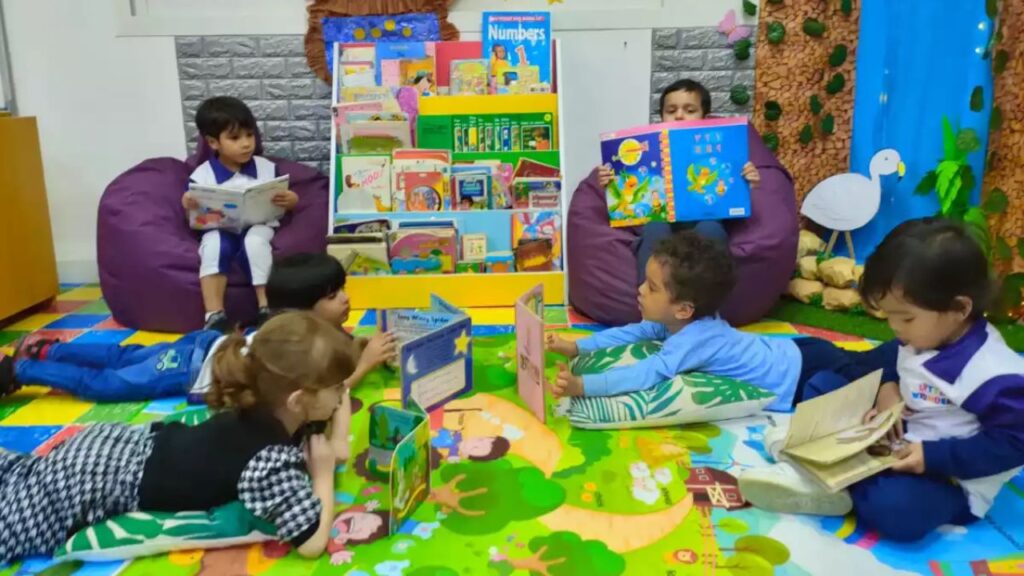 Children enjoying storytime at Little Wonders Nursery, surrounded by colourful books and playful dec.