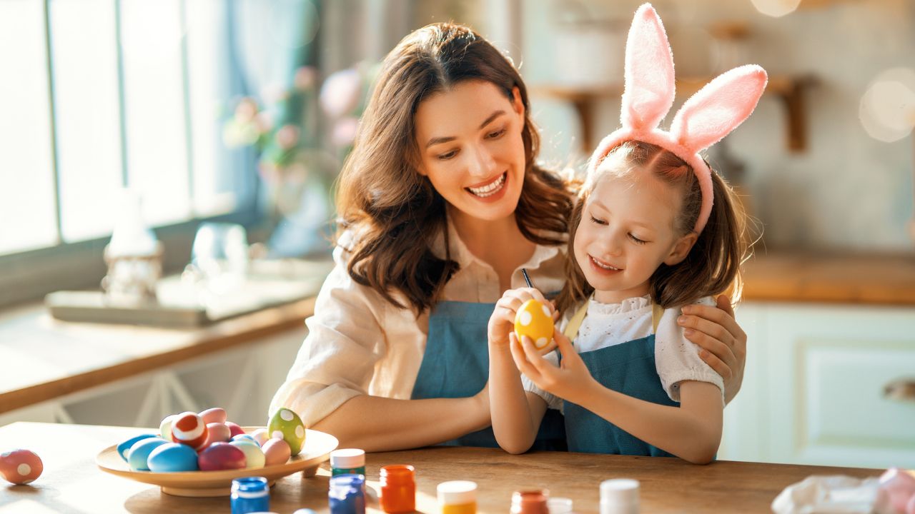 mother and daughter painting easter eggs