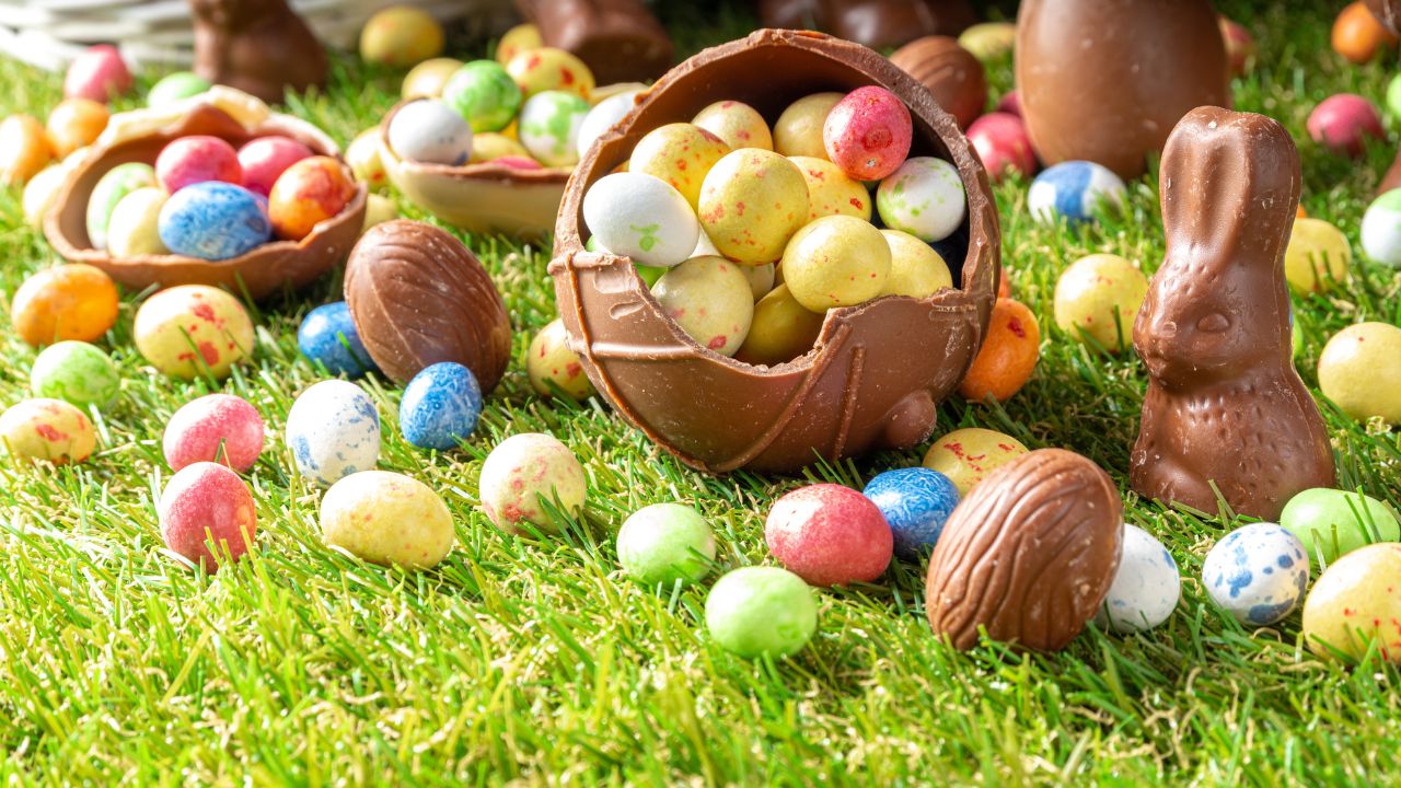 Colourful Easter eggs and chocolates on grass for egg hunt in Dubai.